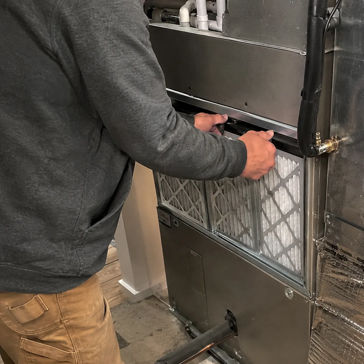 Technician Inspecting Hvac System Airflow Components