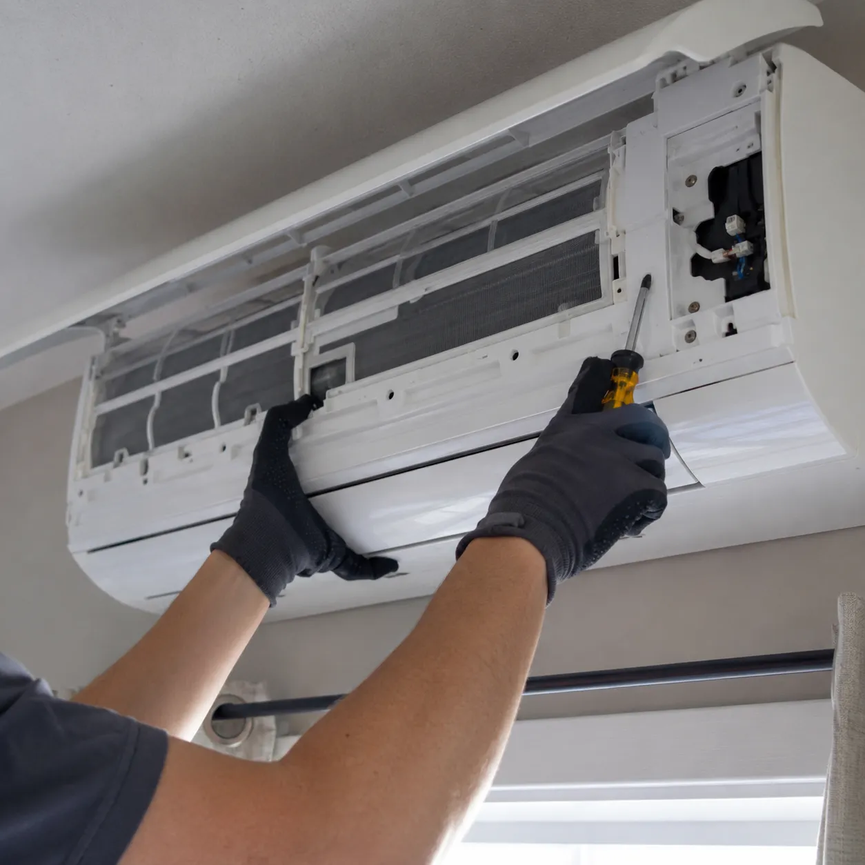 Technician Installing A Ductless Mini Split Indoor Unit